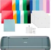 A bundle of crafting supplies including a cutting machine, various colored vinyl sheets, cutting mats, and tools, all arranged on a white background. Produktbild-Vorschau