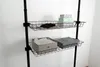 A black wire shelving unit with two shelves, holding folded clothes and storage boxes. Náhled obrázku produktu