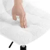 A hand pressing down on a plush white cushion. Produktbild-Vorschau
