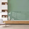 A modern living room setup with a wall unit, shelving, and a chair. Produktbild-Vorschau