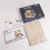 A flat lay of a ROKR wooden puzzle kit, including the box, assembly instructions, and unassembled wooden pieces. Voir les images du produit