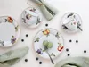 A flat lay of a fruit-themed porcelain tea set with two cups and saucers, two plates, and scattered blueberries and macarons. Náhľad obrázku produktu