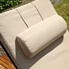 A close-up view of a beige bolster pillow on a beige chaise lounge outdoors. Anteprima dell’immagine prodotto