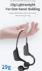 A hand holding a pair of black wireless headphones. Podgląd zdjęcia produktu