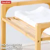 A close-up view of a wooden shelf with white towels on it, suggesting storage or organization. Náhled obrázku produktu