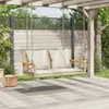 A hanging bench with cushions is suspended from a wooden pergola, set in a garden environment with wooden fencing and greenery. Náhled obrázku produktu