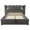 A grey upholstered bed frame with a scalloped headboard and integrated reading lights. Produktbild-Vorschau