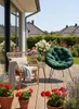 A cozy outdoor seating area on a wooden deck, featuring two chairs, plants, and a garden setting. Produktbild-Vorschau