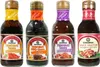 Four bottles of Kikkoman sauces are displayed side-by-side against a white background. Produktbild-Vorschau