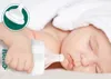 A baby sleeping while holding a baby bottle. Náhľad obrázku produktu