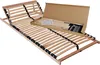 A wooden bed frame with adjustable headrest, shown partially assembled with its packaging and instructions.