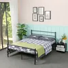 A bedroom scene with a metal bed frame, bedding, a nightstand, and a plant. Voir les images du produit