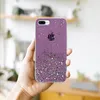 A hand holding a purple glitter phone case with an Apple logo. Náhled obrázku produktu