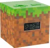 A cube-shaped alarm clock designed to look like a Minecraft block, with a digital display showing the time. Náhľad obrázku produktu