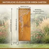 A decorative metal garden screen with a floral cut-out pattern, set in a garden with plants and grass. Produktbild-Vorschau