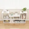 A white, modern loft-style bookshelf filled with books, decorative items, and storage boxes. Podgląd zdjęcia produktu