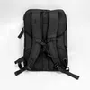 The back of a black backpack is shown against a white background. Produktbild-Vorschau