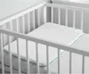 A white baby pillow is placed inside a white crib. Anteprima dell’immagine prodotto
