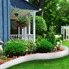 A garden scene with a blue house, porch, hanging flower basket, and manicured bushes, bordered by a white metal garden edging. Voir les images du produit