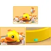 A collage of images showing a yellow duck toy with several smaller white ducklings, and a close-up of a green switch on the toy. Náhľad obrázku produktu