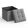 A gray fabric storage ottoman with its lid resting beside it. Produktbild-Vorschau
