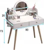 A white vanity table with a lighted mirror and wooden legs, shown with various makeup products on its surface. Náhľad obrázku produktu