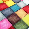 A close-up, angled view of a colorful, checkered rug. Náhled obrázku produktu