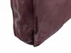 Close-up of the bottom corner of a brown leather bag. Produktbild-Vorschau