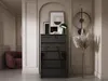 A modern living room scene featuring a black dresser, artwork, and a decorative lamp. Anteprima dell’immagine prodotto