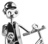 A close-up shot of a metal figurine made from nuts, bolts, and other hardware, depicting a person riding a bicycle. Náhľad obrázku produktu