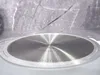 Close-up of the bottom of a pot with engraved text and a textured gray background. Podgląd zdjęcia produktu