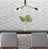 A modern interior scene with textured white wall panels, a minimalist chandelier, and two grey chairs. Podgląd zdjęcia produktu