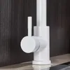 A close-up view of a white kitchen faucet with a dark wood-grained background. Náhľad obrázku produktu