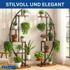 Two modern, multi-tiered plant stands filled with various potted plants are displayed indoors, with a window and curtain in the background. Produktbild-Vorschau