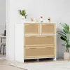 A white and natural wood chest of drawers with rattan fronts is shown in a well-lit room. Podgląd zdjęcia produktu