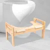 A wooden toilet stool is placed in front of a toilet. Náhled obrázku produktu