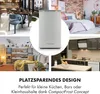 A collage of lifestyle images showcasing a compact freezer in various settings, including a dining area, bedroom, living room, and kitchen, along with text highlighting its space-saving design. Produktbild-Vorschau