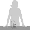 A silhouette of a person is shown behind a small metal figurine on a table, with dimensions indicated. Náhled obrázku produktu