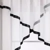 A close-up view of a white sheer curtain with a black satin ribbon trim. Produktbild-Vorschau