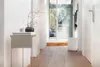 A hallway with a humidifier and a small table with decorative items. Podgląd zdjęcia produktu