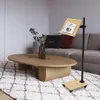A living room scene with a sofa, coffee table, and a rolling book stand. Produktbild-Vorschau