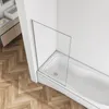 A modern bathroom with a bathtub and a glass shower screen. Produktbild-Vorschau