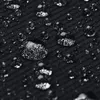 A close-up macro shot of water droplets on a black fabric surface. Voir les images du produit