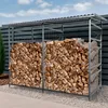 A metal firewood rack filled with firewood, placed outdoors next to a fence. Produktbild-Vorschau