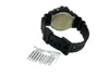 The back of a black digital watch with a label attached to the strap. Náhľad obrázku produktu