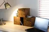 A desk setup with wooden cubes, a laptop, and a lamp. Anteprima dell’immagine prodotto