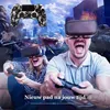 People playing a video game using VR headsets and controllers, with a digital background depicting a battle scene. Produktbild-Vorschau