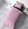 A pink and anthracite duvet cover set laid out on a bed. Produktbild-Vorschau