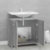A bathroom vanity cabinet with a sink installed above it, set against a tiled wall. Produktbild-Vorschau