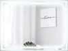 A modern bathroom mirror with integrated LED lighting, reflecting a minimalist interior with a framed artwork and a plant. Náhled obrázku produktu